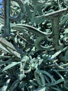 close up photo of a large sculpture made of wrought iron letters of the English alphabet